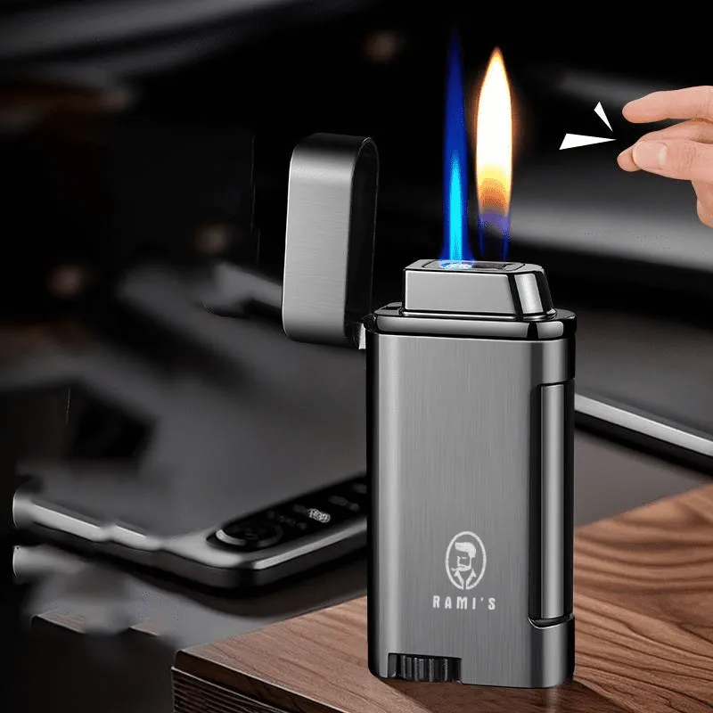 A gunmetal grey Rami's Accessories lighter with an open lid, displaying a unique dual flame consisting of a blue torch and a soft yellow flame, being activated by a hand snap.