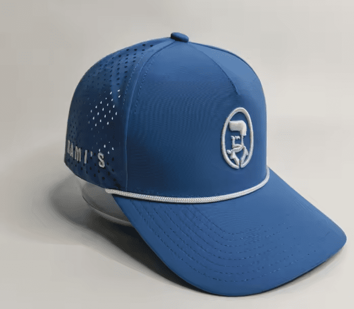 A studio product shot of a cobalt blue Rami's Apex Performance Cap, featuring a white rope trim on the brim, laser-perforated side panels for breathability, and the signature "Rami's" brand logo embroidered in white on the front.
