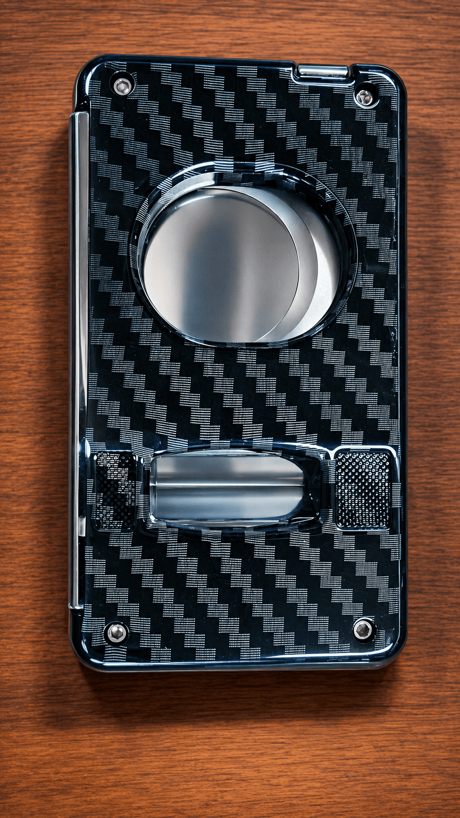 Back view of Rami's Carbon Elite Cutter featuring a luxury carbon fiber finish, integrated draw poker, and compact 4-in-1 cigar accessory design.