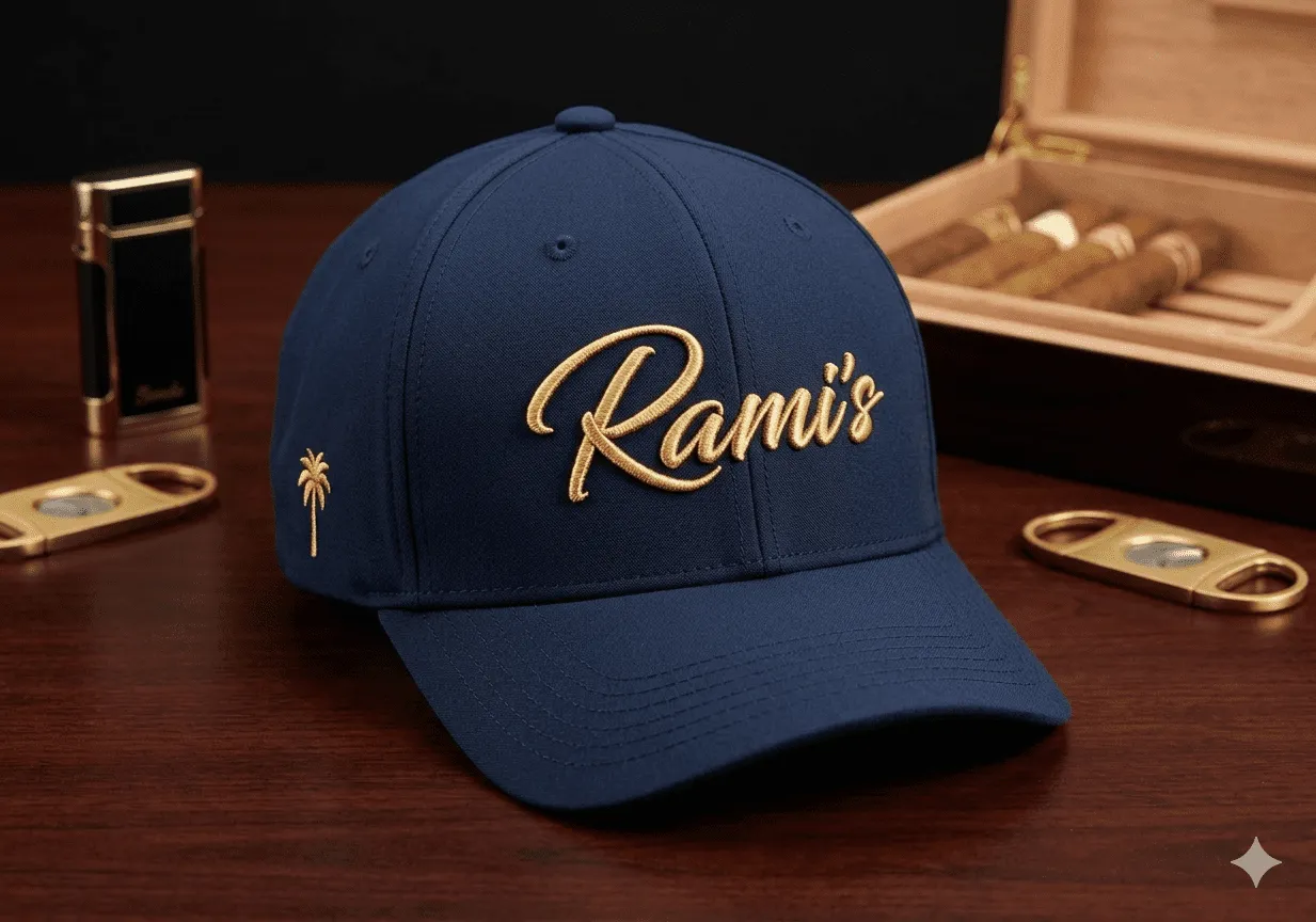 Rami's Palm premium performance baseball cap in navy blue, featuring the gold embroidered "Rami's" script logo on the front and a gold palm tree icon on the side panel.