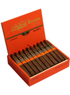 Aging Room Quattro Nicaragua cigar with dark wrapper and gold-accented band resting on wood