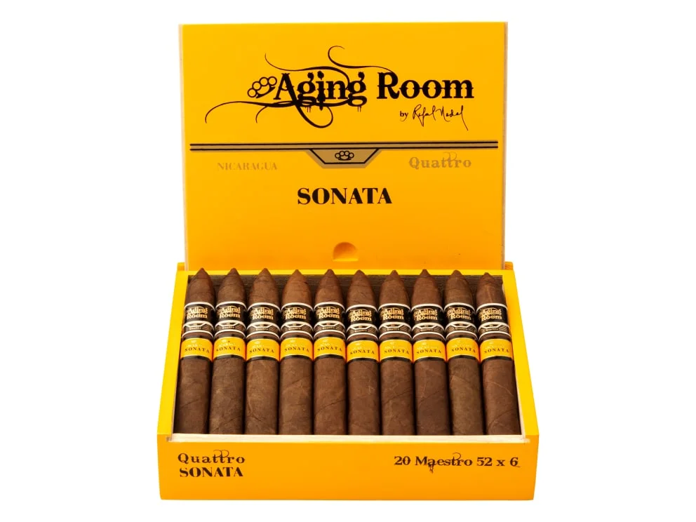 Open box of Aging Room Quattro Sonata Maestro cigars with reddish-brown wrappers and gold-trimmed bands