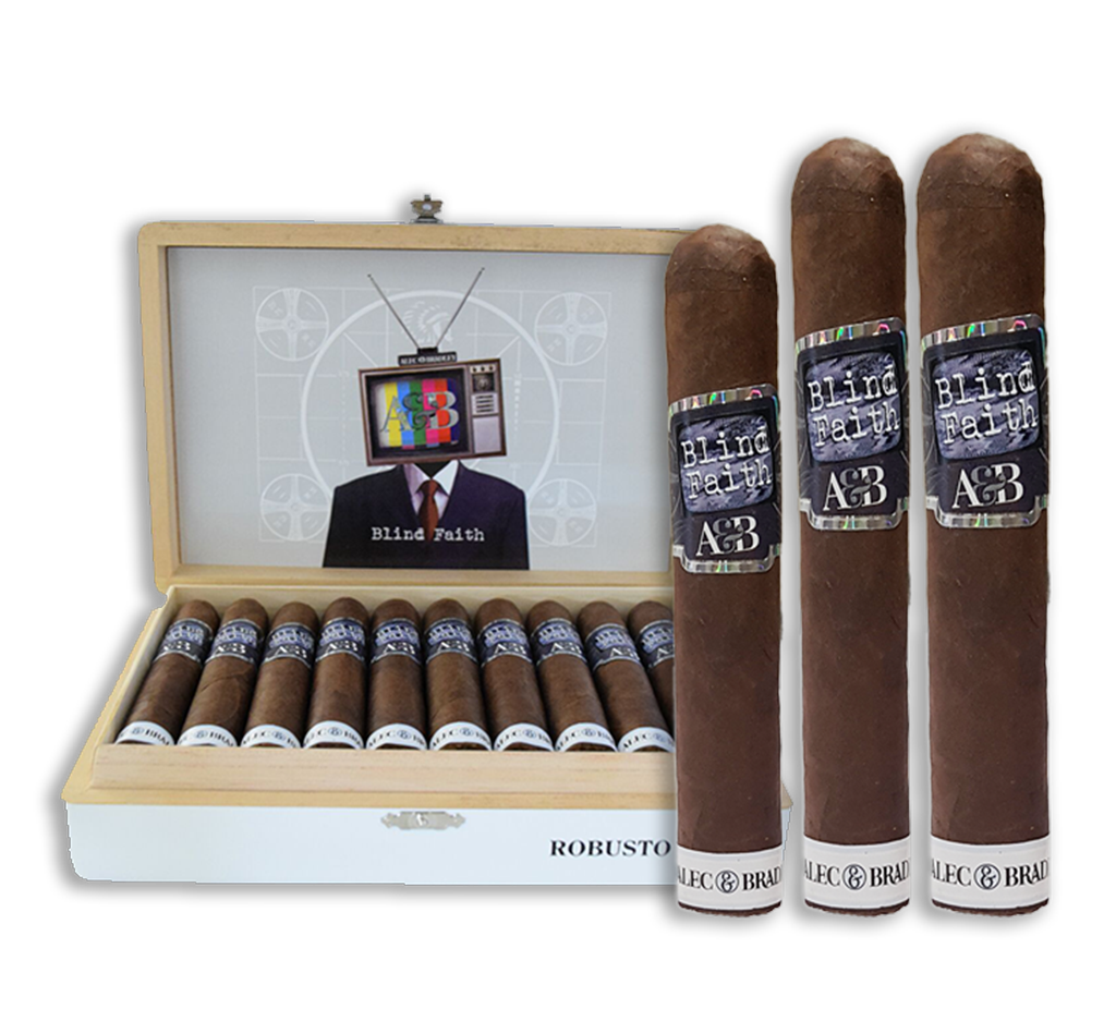 Three Alec Bradley Blind Faith cigars displayed in front of an open box filled with cigars.