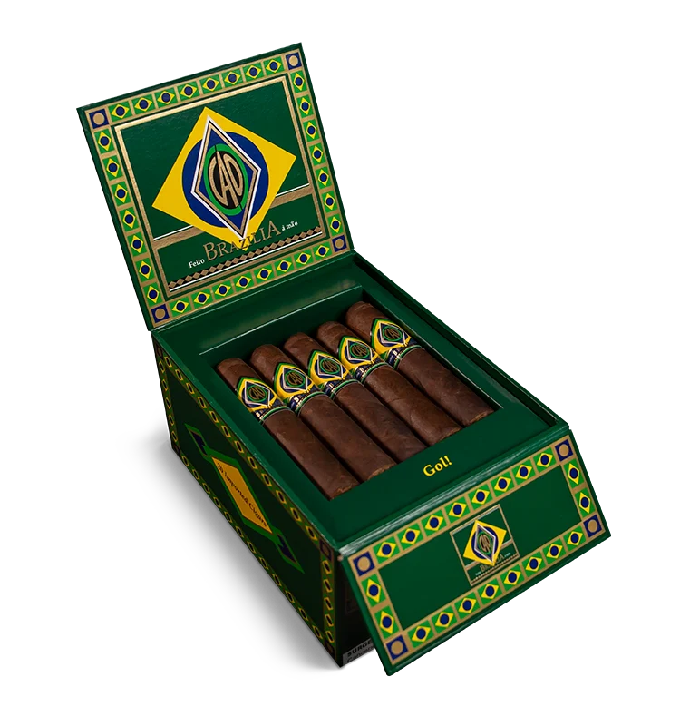 Open box of CAO Brazilia cigars with dark, oily Brazilian Maduro wrappers and bold branding.