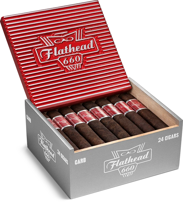 Open box of CAO Flathead cigars with dark, box-pressed wrappers and retro automotive-themed packaging.