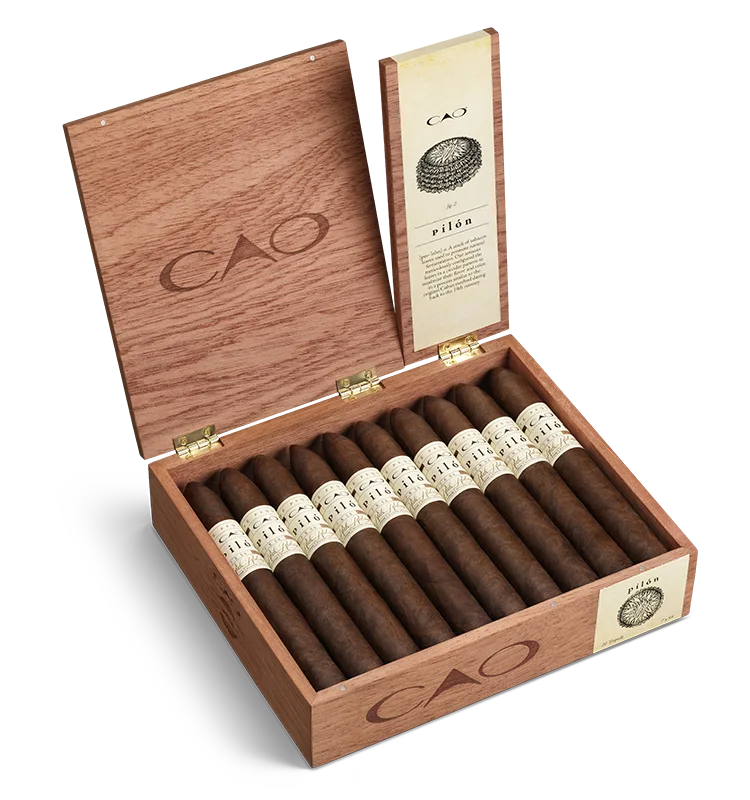 Open box of CAO Pilon cigars with reddish-brown Honduran wrappers and distinct, classic branding