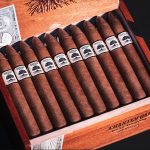 Open box of Charter Oak Habano cigars, featuring rich, golden-brown wrappers neatly arranged in a rustic wooden box