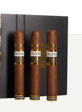 Four Plasencia Cosecha 151 cigars resting on a box of the same, showcasing their rich, dark wrappers and premium craftsmanship