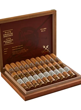 Open box of Montecristo Espada cigars with rich brown Nicaraguan wrappers and detailed gold-accented bands.