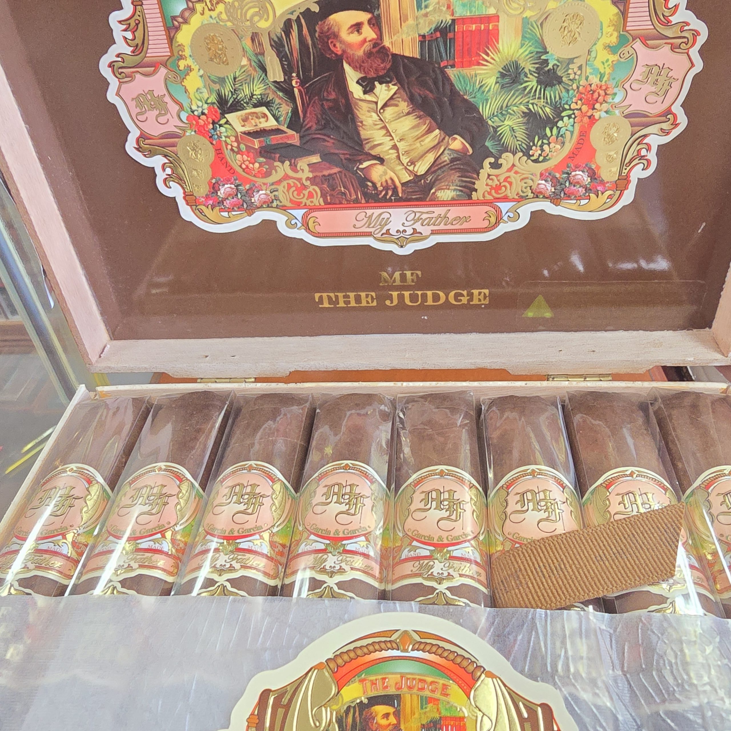 : Open box of My Father The Judge cigars neatly arranged