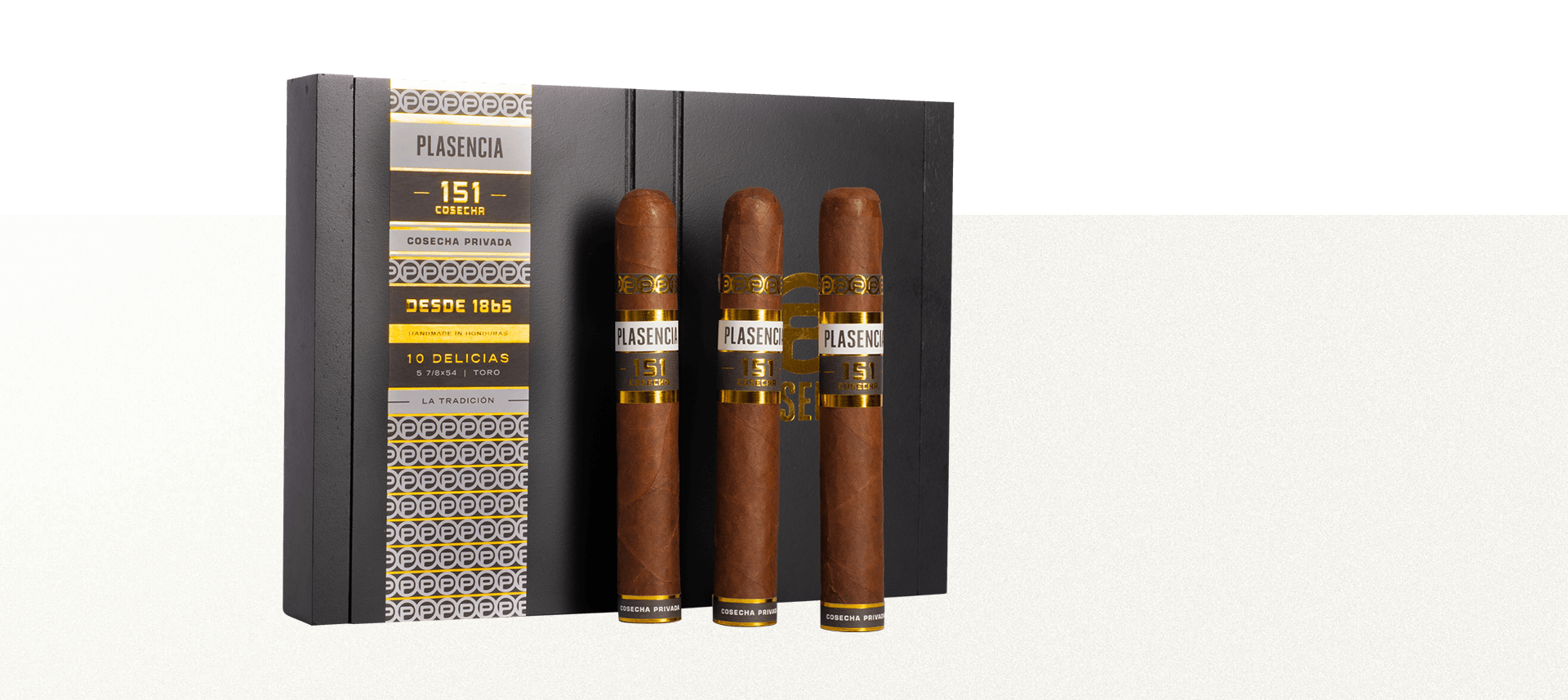 Four Plasencia Cosecha 151 cigars resting on a box of the same, showcasing their rich, dark wrappers and premium craftsmanship