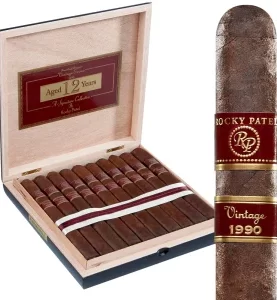Open box of Rocky Patel 1990 Broadleaf cigars, featuring the dark, rich broadleaf wrappers and neat arrangement inside