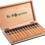 Open box of Sin Compromiso cigars with dark wrappers and elegant black-and-silver bands