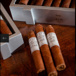 Three Gurkha Cellar Reserve Platinum 12 Year cigars laying on wooden surface