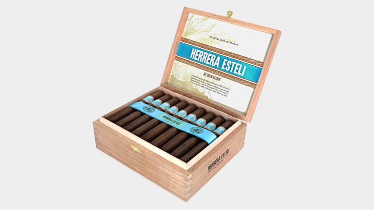 Open box of Herrera Estelí Brazilian Maduro cigars showcasing dark, rich wrappers.