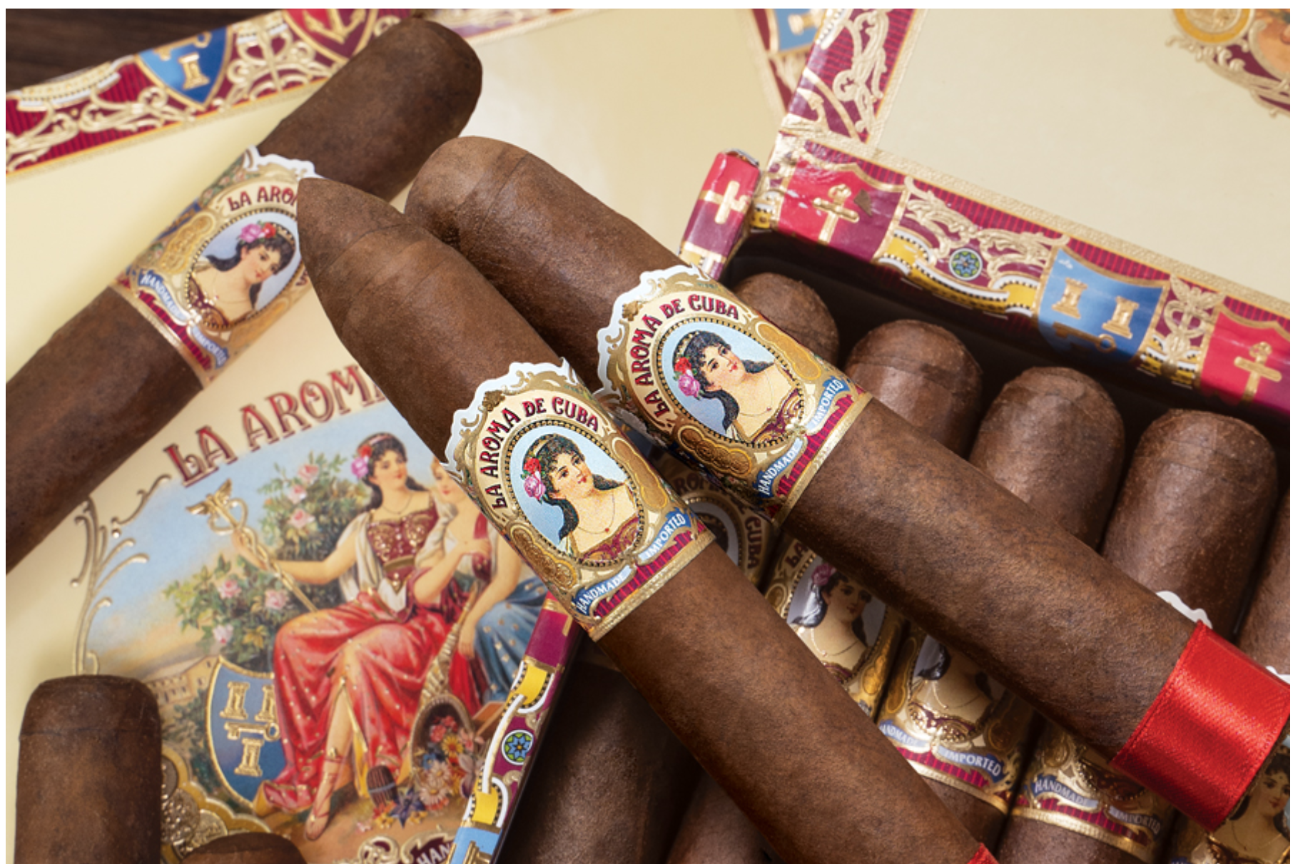 Box of La Aroma de Cuba Original cigars arranged neatly with vintage-style bands and rich brown wrappers.