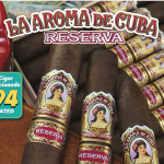 Box of La Aroma de Cuba Reserva cigars with dark, oily wrappers and vintage-style bands neatly arranged in cedar box.