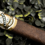 Single Laranja Escuro cigar with a dark, oily Brazilian Mata Fina wrapper and a refined, richly designed band.