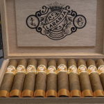 Open box of Laranja Reserva cigars with a beautiful Brazilian Laranja wrapper, neatly arranged, showcasing the elegant packaging and premium construction