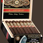 An open box of Perdomo 20th Anniversary Maduro cigars, showcasing dark, oily wrappers and elegant gold-and-blue bands, neatly arranged inside a premium wooden box.