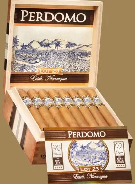 "An open box of Perdomo Lot 23 Connecticut cigars, showcasing the light, smooth wrappers and distinct Padron bands, neatly arranged inside a premium wooden box.