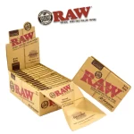 Display of RAW Classic Artesano 1 1/4 rolling papers with integrated tips and foldable tray, arranged in branded cardboard box.