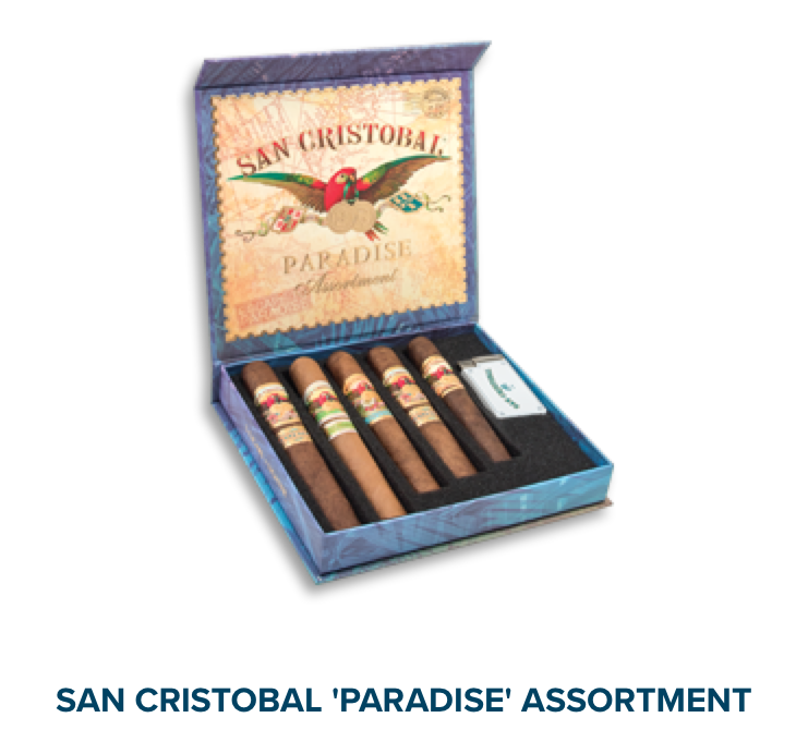 Open box of San Cristobal Paradise Assortment with premium cigars and a branded lighter