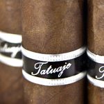 Four loose Tatuaje Black Label cigars with dark, oily sun-grown wrappers arranged side by side