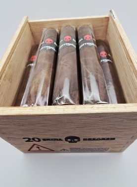 Open box of Tatuaje Surrogates cigars with dark wrappers and bold modern bands arranged in a rustic wooden box.