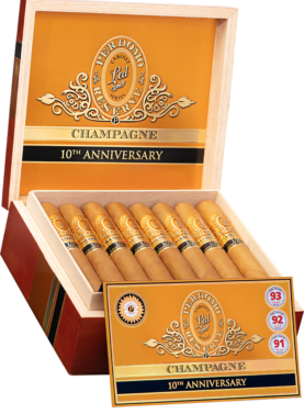 An open box of Perdomo 10th Anniversary Champagne cigars, featuring the light, smooth wrappers and gold bands, elegantly arranged inside the box.