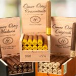 Three open boxes of Omar Ortez cigars showing Connecticut and Maduro wrappers, neatly arranged with visible cigar bands.