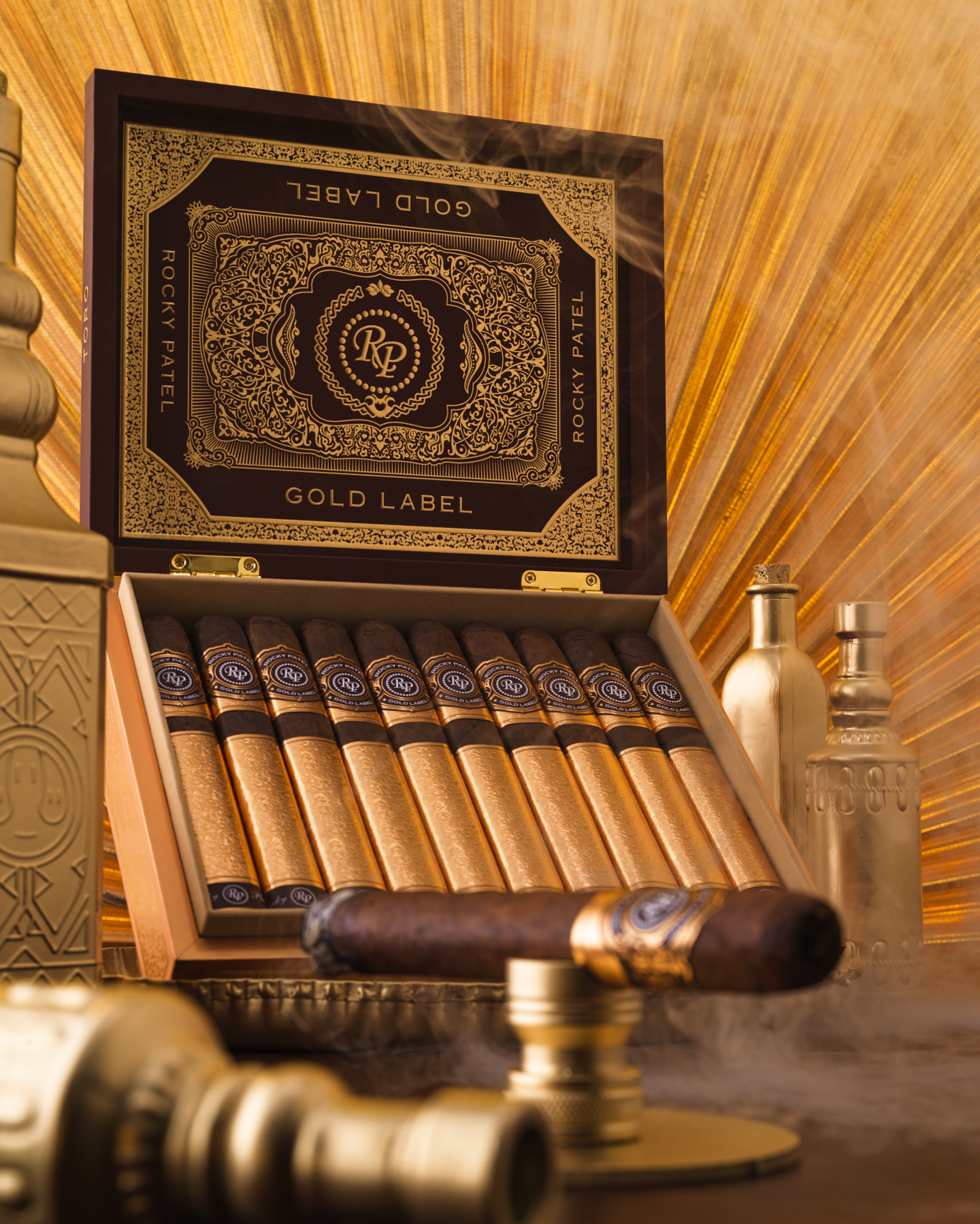 Open box of Rocky Patel Gold Label cigars, showcasing perfectly arranged cigars with elegant, gold-accented packaging.