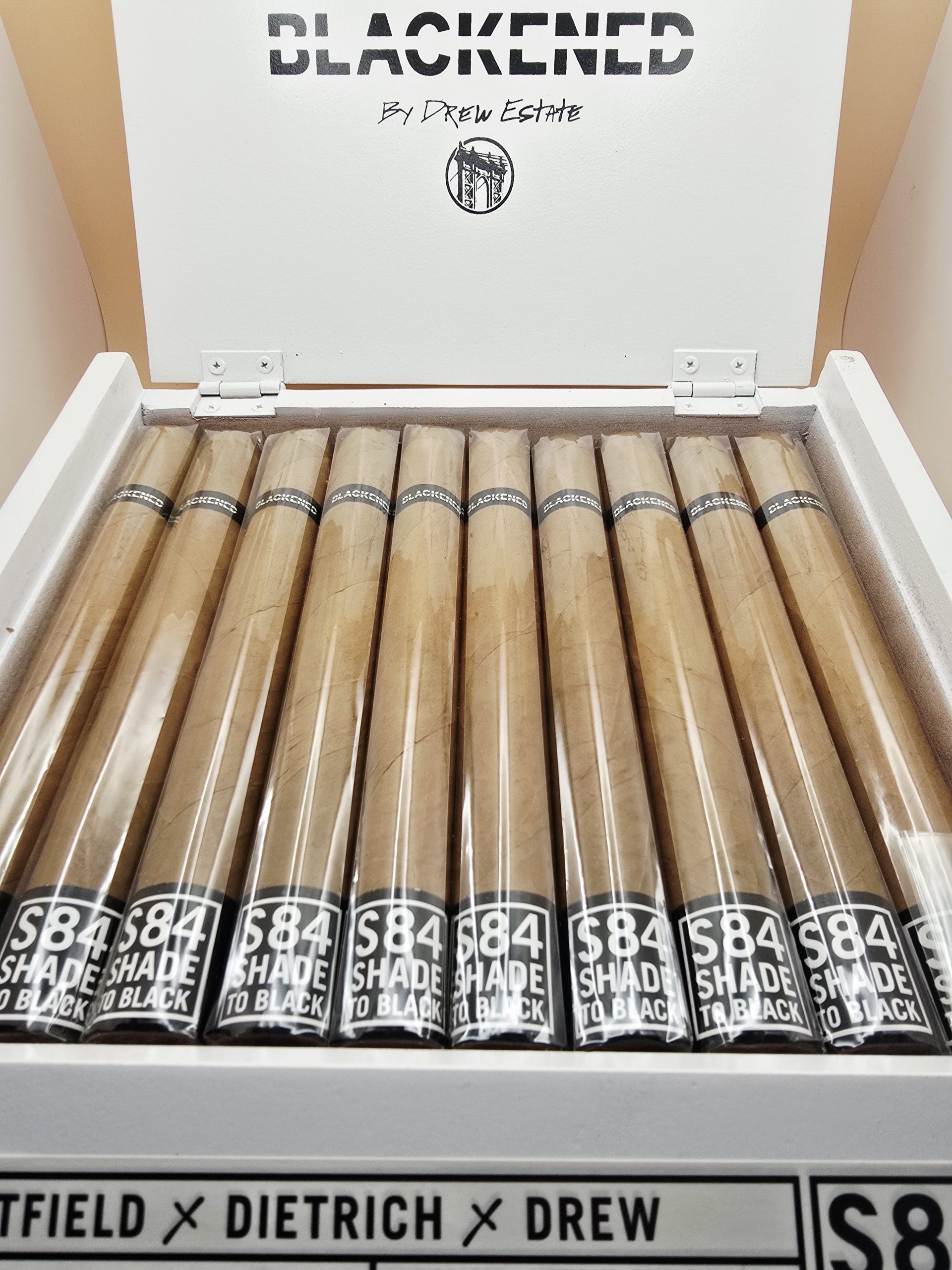 "Blackened M81 Shade cigars displayed in an open box, showcasing their smooth, creamy profile."