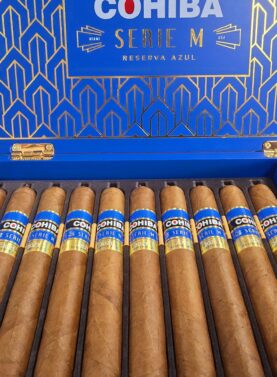 Open box of Cohiba Serie M Reserva Azul premium cigars with rich blue accents