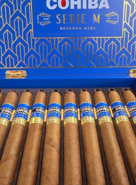 Open box of Cohiba Serie M Reserva Azul premium cigars with rich blue accents