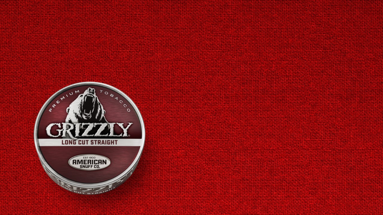 A can of Grizzly Long Cut Straight smokeless tobacco with its signature red label and bear logo.