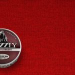 A can of Grizzly Long Cut Straight smokeless tobacco with its signature red label and bear logo.