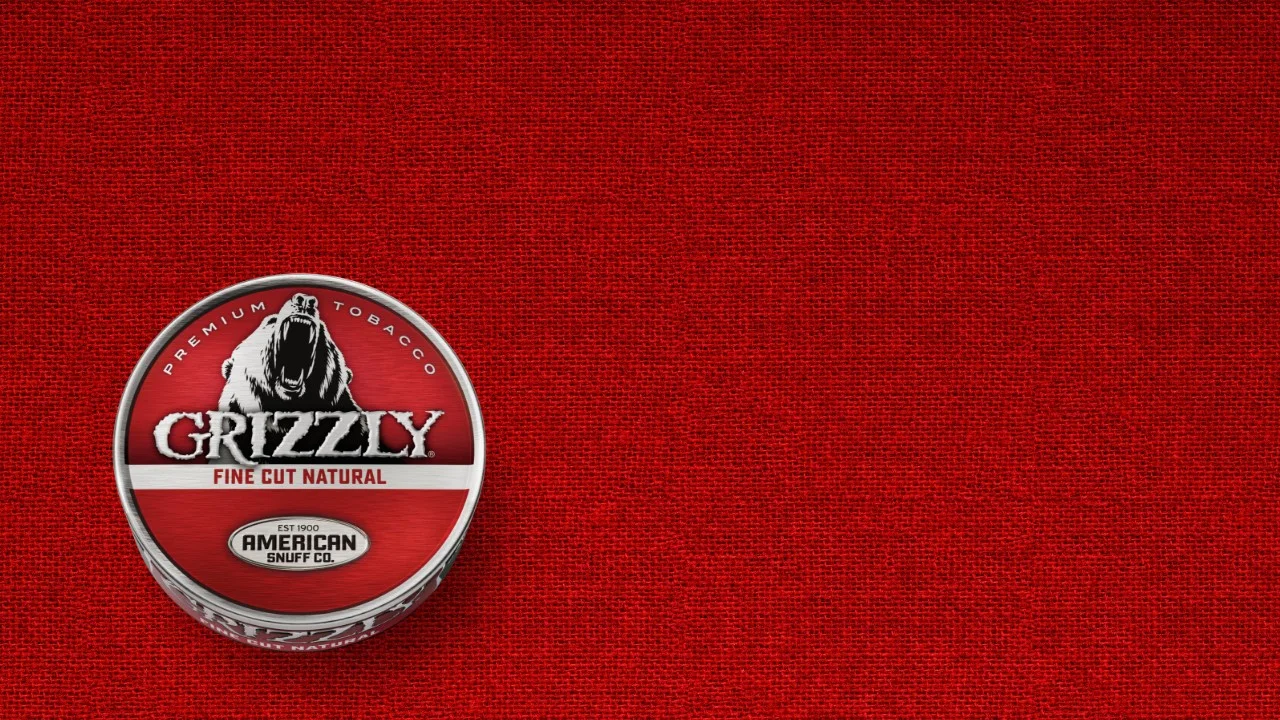 A can of Grizzly Natural Fine Cut smokeless tobacco featuring its tan-colored label and Grizzly bear logo.
