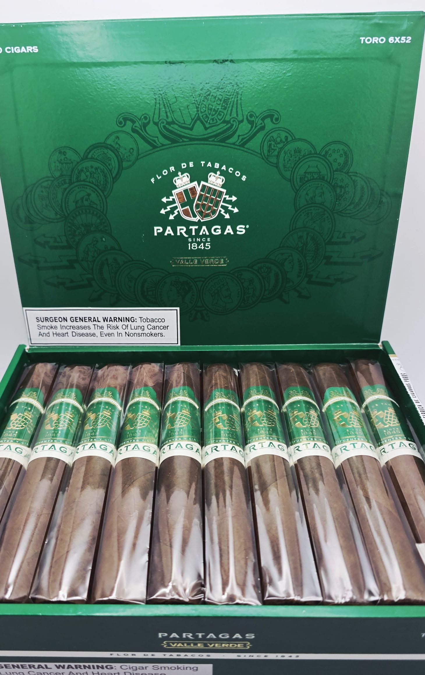 Open box of Partagás Valle Verde cigars with smooth Ecuadorian Habano wrappers and elegant green and gold bands.