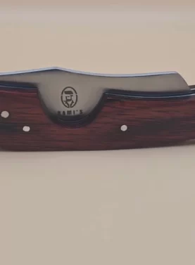 Rami's cigar knife with red wood handle and stainless steel blade displayed on a neutral background