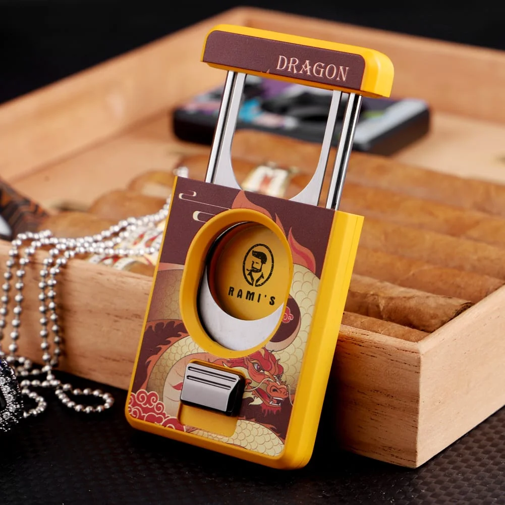 Rami’s Year of the Dragon Cigar Cutter in silver finish placed beside a wooden cigar box