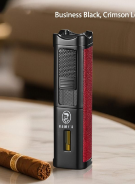 A tall, matte black Rami's Accessories executive lighter with textured crimson leather siding, a fuel window, and the brand logo, standing on a marble table next to a cigar.