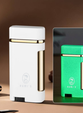 A sleek Pearl White Rami's Accessories lighter with polished gold trim, standing upright on a desk surface.