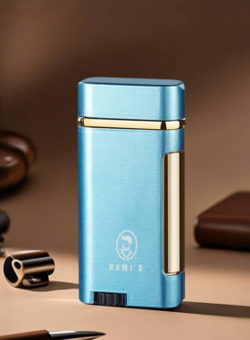A sleek Arctic Blue Rami's Accessories lighter with polished gold trim, standing upright on a desk next to a coffee cup and leather stationery.