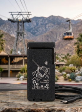 Rami's Tramway Summit rechargeable lighter with custom tramway engraving, Palm Springs mountain backdrop, and USB-C charging cable.