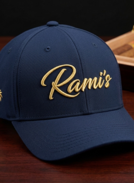 Rami's Palm premium performance baseball cap in navy blue, featuring the gold embroidered "Rami's" script logo on the front and a gold palm tree icon on the side panel.