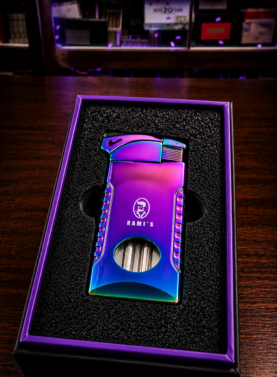 A "Rami's" Pipeliner cigar lighter with a striking iridescent prism finish, nestled in a matching purple-bordered presentation box.